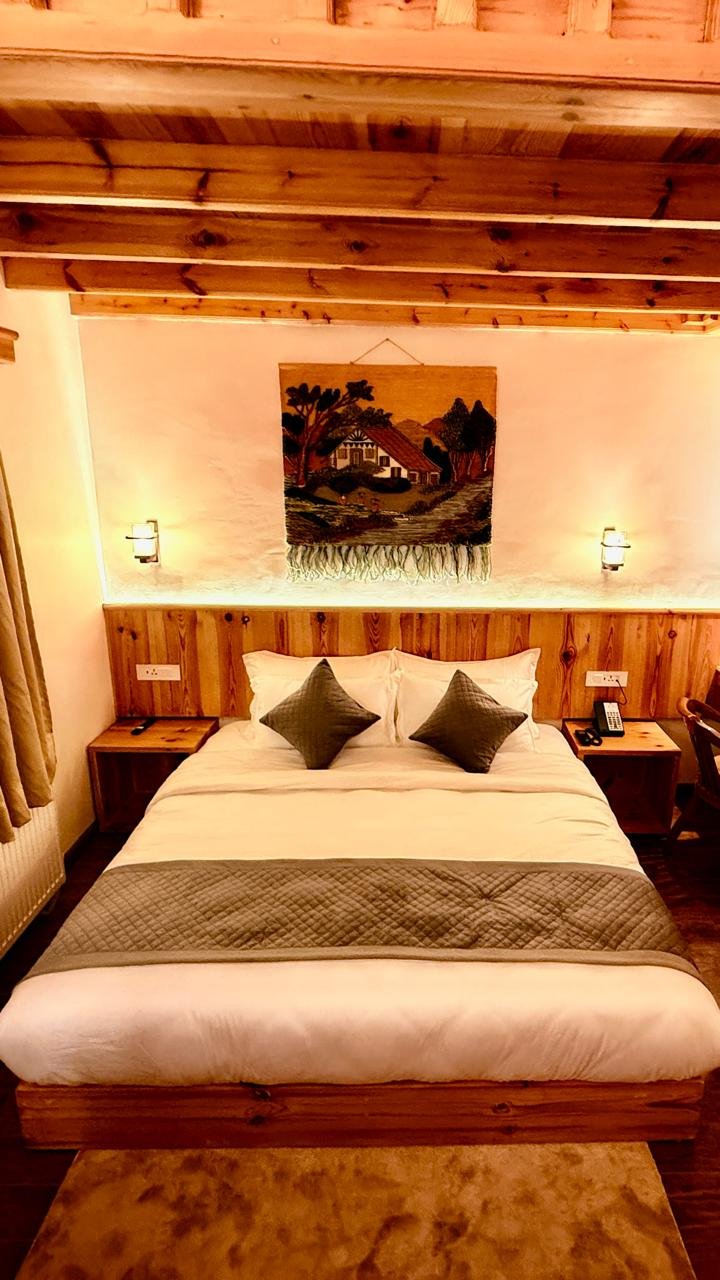 Bedroom setup with mountain view at Pear Meadows Tangmarg